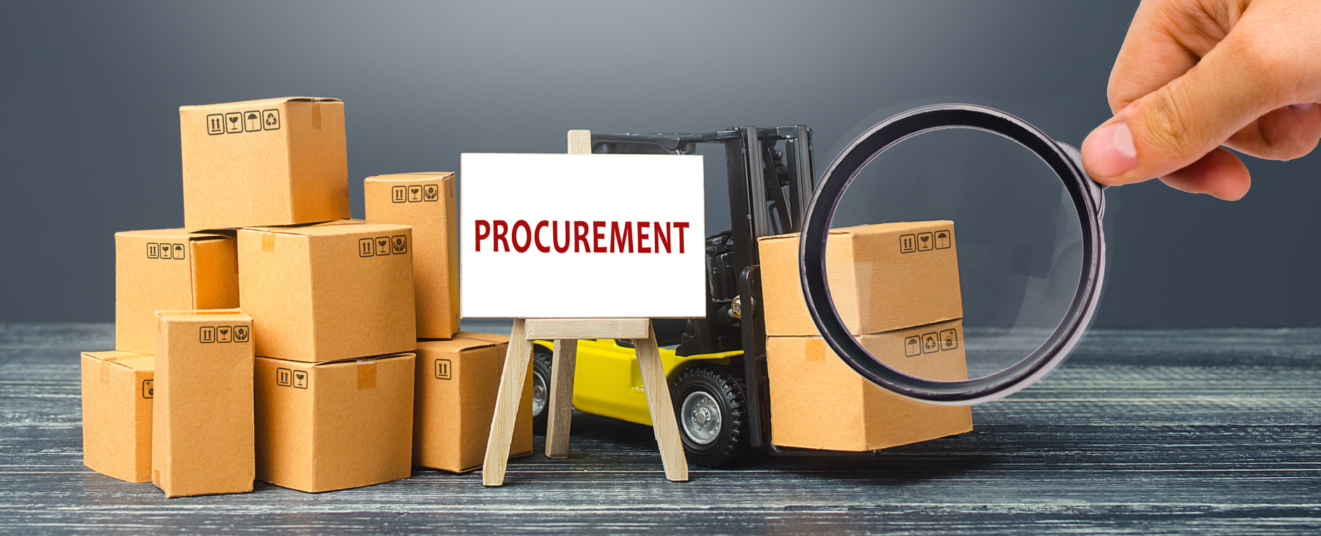 Yellow Forklift truck with cardboard boxes and stand with the word Procurement. Logistics, warehousing, transportation of goods, inspection and storage. Procurement management industry concept.